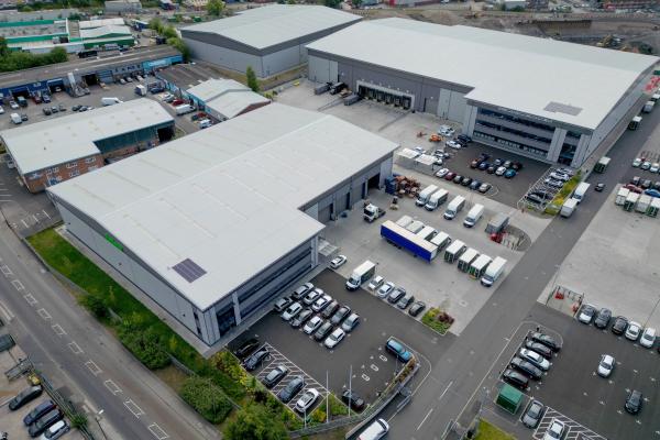 Aerial view of Impact Park, a large unit with cars parked outside