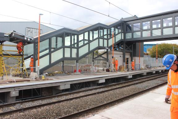 Construction workers and a new bridge over a railway line