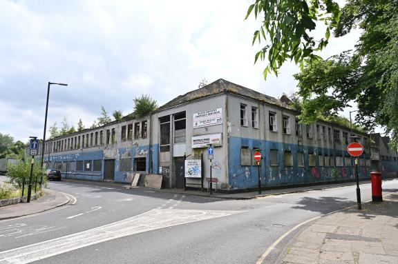 Derelict blue and white Victorian factory building on the corner of Moat Street in Willenhall