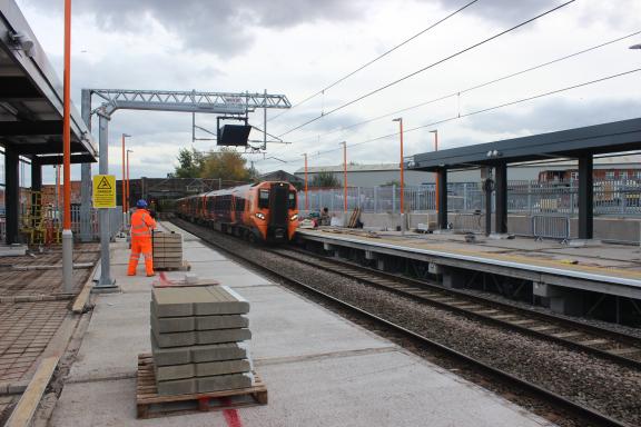 The new train platforms under construction as a train passes through