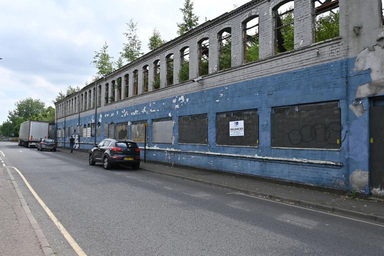 Derelict blue and white Victorian factory building on Moat Street in Willenhall