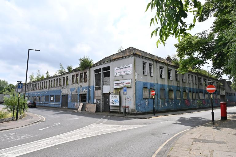 Derelict blue and white Victorian factory building on the corner of Moat Street in Willenhall