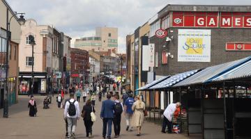 Pedestrians in Walsall town centre with New Art Gallery in background