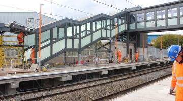 Construction workers and a new bridge over a railway line