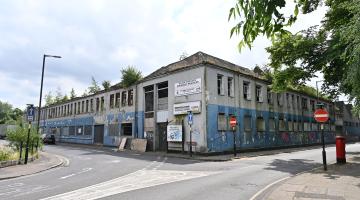 Derelict blue and white Victorian factory building on the corner of Moat Street in Willenhall