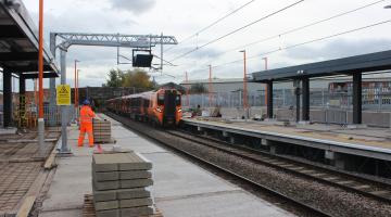 The new train platforms under construction as a train passes through